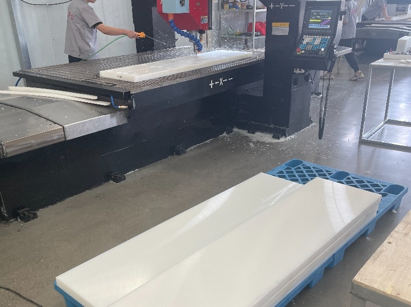 Close view of machined UHMWPE surface with rough texture and tool marks