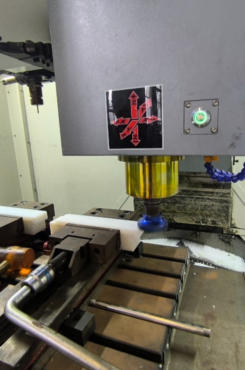 UHMWPE plastic block secured with distributed clamping on CNC fixture