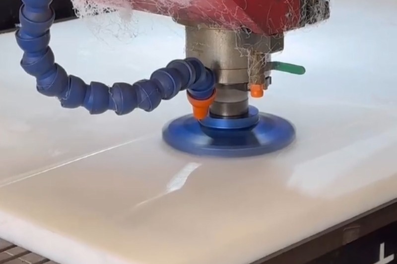 UHMWPE block with visible machining marks and minor surface distortion